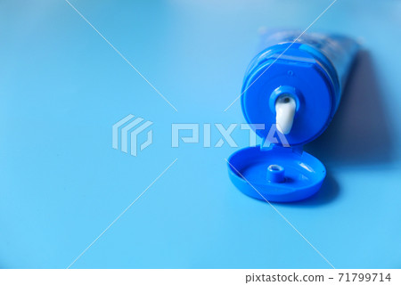 Close up of face cream in a container on blue background Close up of face cream in a container on blue background 71799714