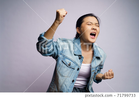 Asian woman shouting isolated over white background. Asian woman shouting isolated over white background. 71799733