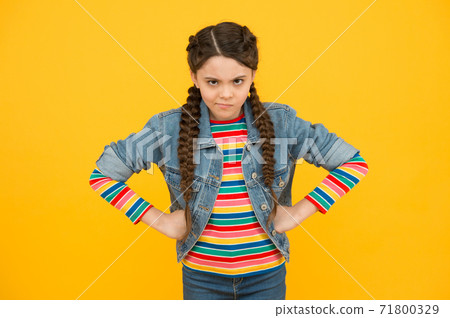 In bad humor. Moody little child yellow background. Little baby wear braided In bad humor. Moody little child yellow background. Little baby wear braided 71800329