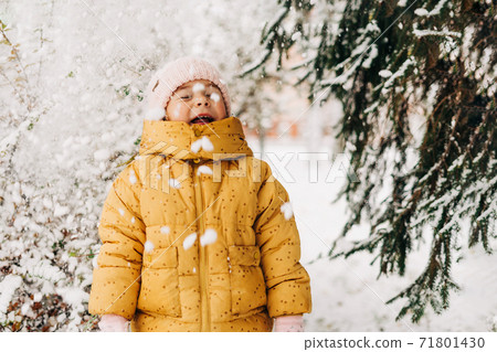 Toddler girl happy with snow day in winter. Playing outside on Christmas holiday 71801430