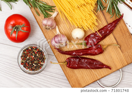 Spaghetti and ingredients for cooking meat or fish on wooden board. Spaghetti and ingredients for cooking meat or fish on wooden board. 71801748
