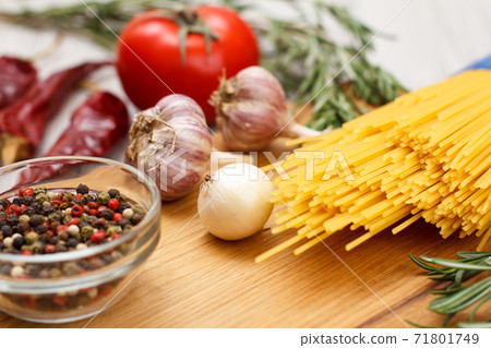 Spaghetti and ingredients for cooking meat or fish on wooden boards. Spaghetti and ingredients for cooking meat or fish on wooden boards. 71801749