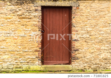 Old wooden door in the stone 71801825