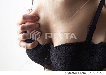 Young girl with hands on black bra Young girl with hands on black bra 71802156