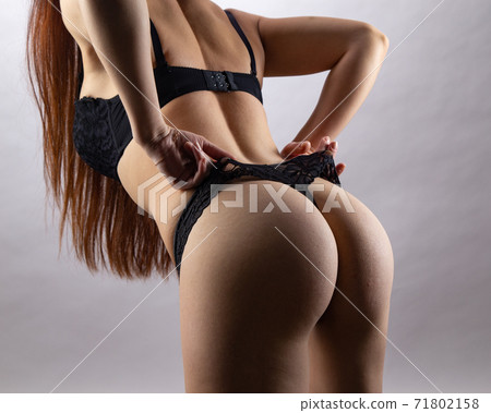 Image of young sexual girl in black lingerie on grey background 71802158