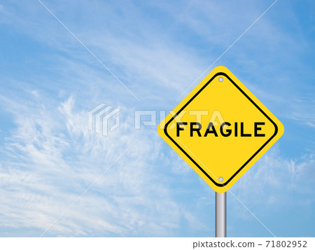 Yellow transportation sign with word fragile on blue sky background Yellow transportation sign with word fragile on blue sky background 71802952