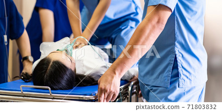 Medical team do CPR to injured patient on gurney Panorama 71803832