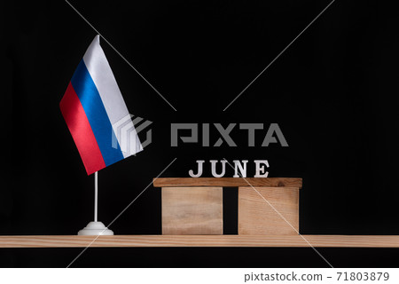 Wooden calendar of June with Russian flag on black background. Dates in Russia in June Wooden calendar of June with Russian flag on black background. Dates in Russia in June 71803879