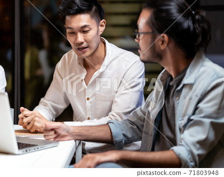 Asian businessman working late with interracial business team brainstorm idea meeting. Asian businessman working late with interracial business team brainstorm idea meeting. 71803948