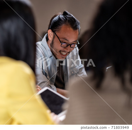 Asian businessman working late with interracial business team brainstorm idea meeting. Asian businessman working late with interracial business team brainstorm idea meeting. 71803949