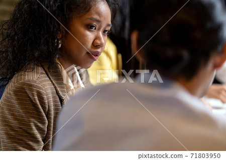 African black woman working late with interracial business team brainstorm idea meeting. African black woman working late with interracial business team brainstorm idea meeting. 71803950