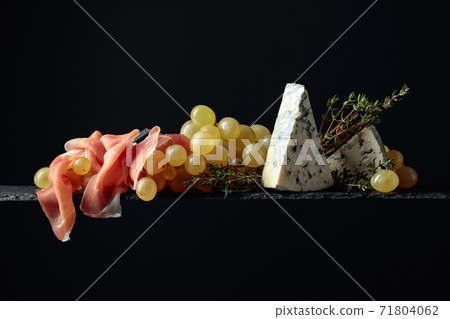 Mediterranean snacks. Grapes with blue cheese, prosciutto and thyme. Mediterranean snacks. Grapes with blue cheese, prosciutto and thyme. 71804062