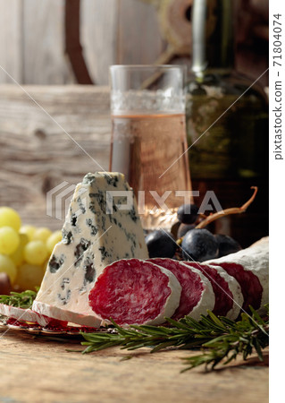 Rustic still life with white wine and snacks. Rustic still life with white wine and snacks. 71804074