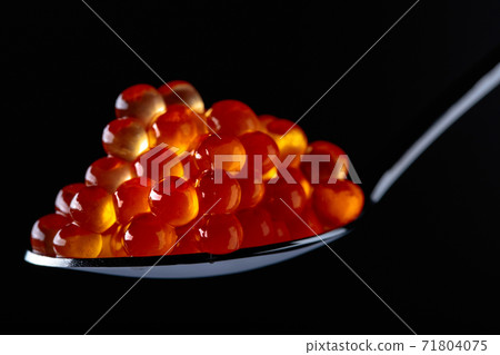 Red caviar in spoon. 71804075