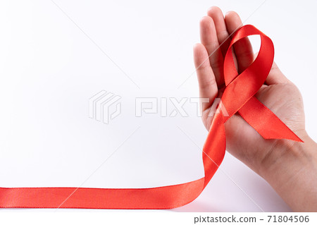 Aids awareness, woman hands holding red ribbon on white background with copy space for text. World Aids Day, Healthcare and medical concept. 71804506
