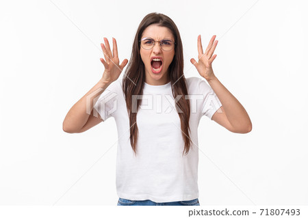 Waist-up portrait of angry, pissed-off brunette pretty girl in glasses, shouting, blaming partner for cheating on her, shaking hands and screaming, having confrontation, frowning aggressive Waist-up portrait of angry, pissed-off brunette pretty girl in glasses, shouting, blaming partner for cheating on her, shaking hands and screaming, having confrontation, frowning aggressive 71807493