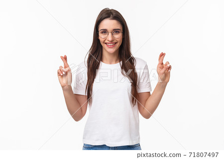 Waist-up portrait of optimistic girl believe dreams do come true, wear glasses and t-shirt, cross fingers good luck, make wish, praying and anticipating positive results, white background 71807497