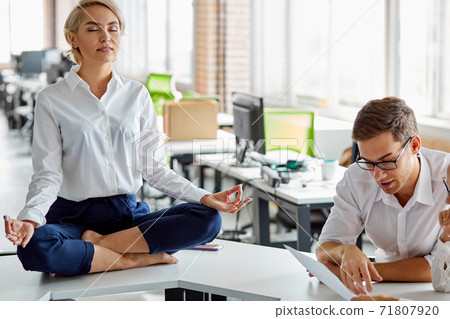 business womans meditating at work place on table 71807920