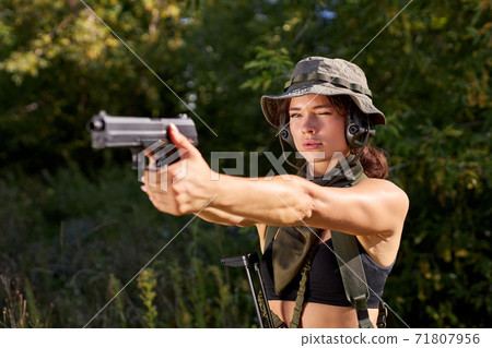 brave soldier woman practice shooting from gun brave soldier woman practice shooting from gun 71807956