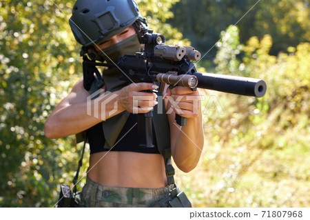 sexy slender woman soldier shooting with rifle machine gun in the wild forest sexy slender woman soldier shooting with rifle machine gun in the wild forest 71807968