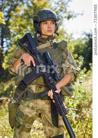 strong brave female army soldier with rifle machine gun standing in the forest strong brave female army soldier with rifle machine gun standing in the forest 71807988