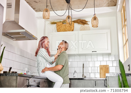 beautiful couple at home in the kitchen, enjoying spending time together beautiful couple at home in the kitchen, enjoying spending time together 71808794