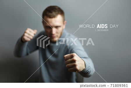 Man stands in boxing stance World AIDS Day concept 71809361