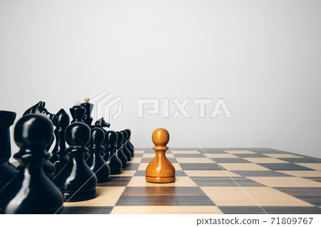 Chessboard with wooden figures against grey background 71809767