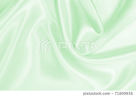 Smooth elegant green silk or satin luxury cloth texture as abstract background. Luxurious background design 71809938