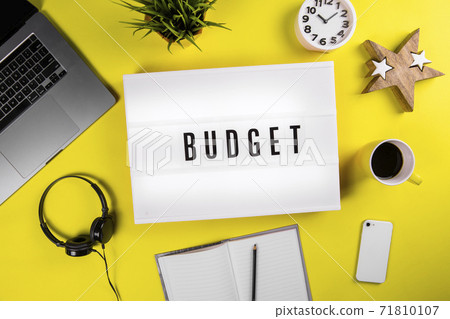 Budget word text on lightbox on modern yellow office desktop 71810107