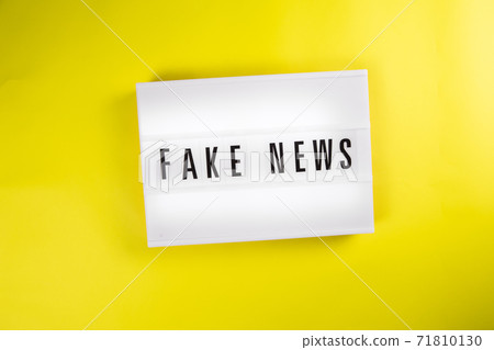 Fake News text on lightbox on yellow background isolated. vintage billboard 71810130