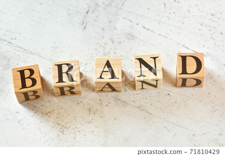 Five wooden cubes with word BRAND on white stone like board, view from above 71810429