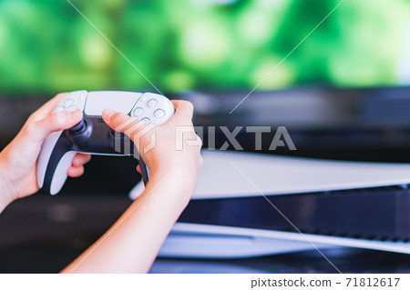 Teenager playing with a game controller [e-sports] 71812617