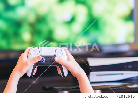 Teenager playing with a game controller [e-sports] 71812619