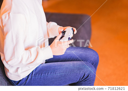 Teenager playing with a game controller [e-sports] 71812621