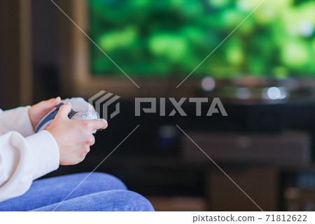 Teenager playing with a game controller [e-sports] 71812622