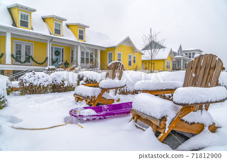 Winter in Daybreak with view of a purple sled in the middle of wooden chairs Winter in Daybreak with view of a purple sled in the middle of wooden chairs 71812900