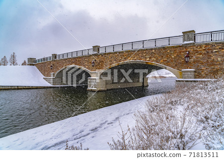 Oquirrh Lake with view of snowy trail and bridge Oquirrh Lake with view of snowy trail and bridge 71813511