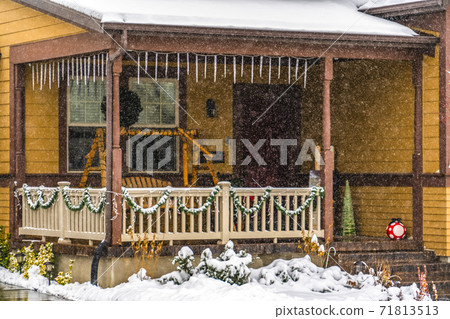 Rustic brown home in Daybreak Utah viewed through falling snow in winter Rustic brown home in Daybreak Utah viewed through falling snow in winter 71813513