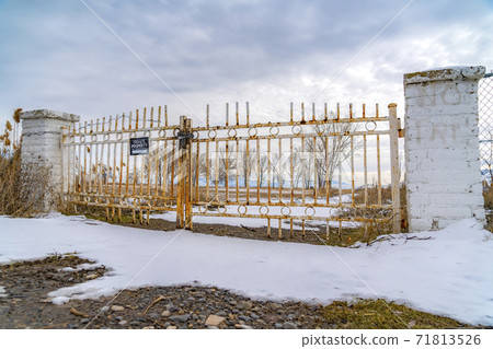 Private property with a No Trespassing sign on the rusty gate viewed in winter Private property with a No Trespassing sign on the rusty gate viewed in winter 71813526