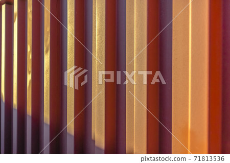 Close up view of a reddish brown corrugated wall on a sunny day Close up view of a reddish brown corrugated wall on a sunny day 71813536