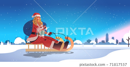 girl in santa claus costume riding sledge happy new year merry christmas holidays celebration concept girl in santa claus costume riding sledge happy new year merry christmas holidays celebration concept 71817537