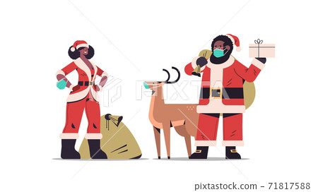 african american man woman in masks wearing santa claus costumes happy new year merry christmas holiday african american man woman in masks wearing santa claus costumes happy new year merry christmas holiday 71817588
