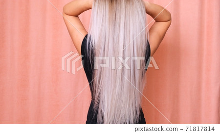 Beautiful female long straight blond hair. Dyed wavy white blond hair background, dyeing, extensions 71817814