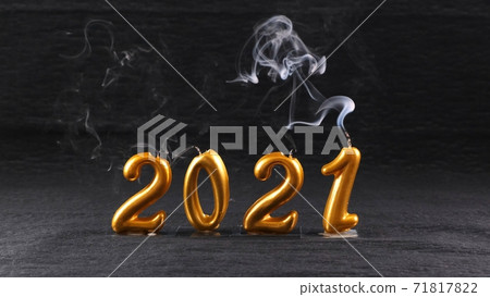 extinguished golden New Year 2021 candles on black background. modern concept. extinguished golden New Year 2021 candles on black background. modern concept. 71817822