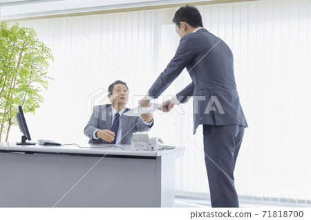 Businessman handing the document Businessman handing the document 71818700