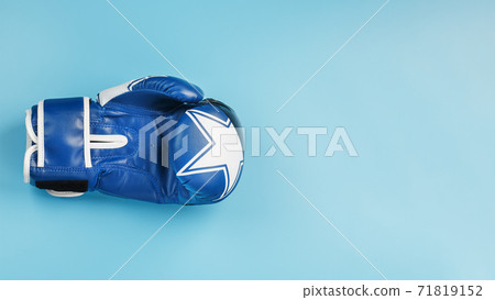 Blue Boxing glove on a blue background, free space. 71819152