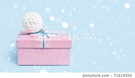 Red Christmas gift box with white bauble on blue Red Christmas gift box with white bauble on blue 71819568