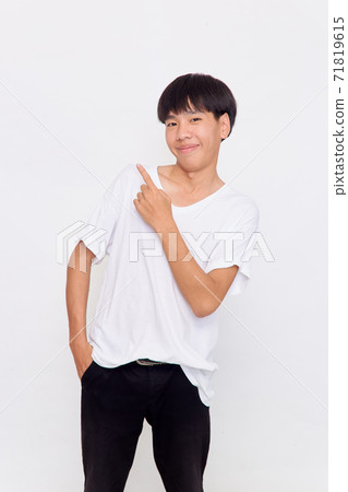 a young man with hand point on empty space a young man with hand point on empty space 71819615