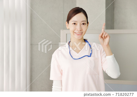 Healthcare worker in pointing pose 71820277